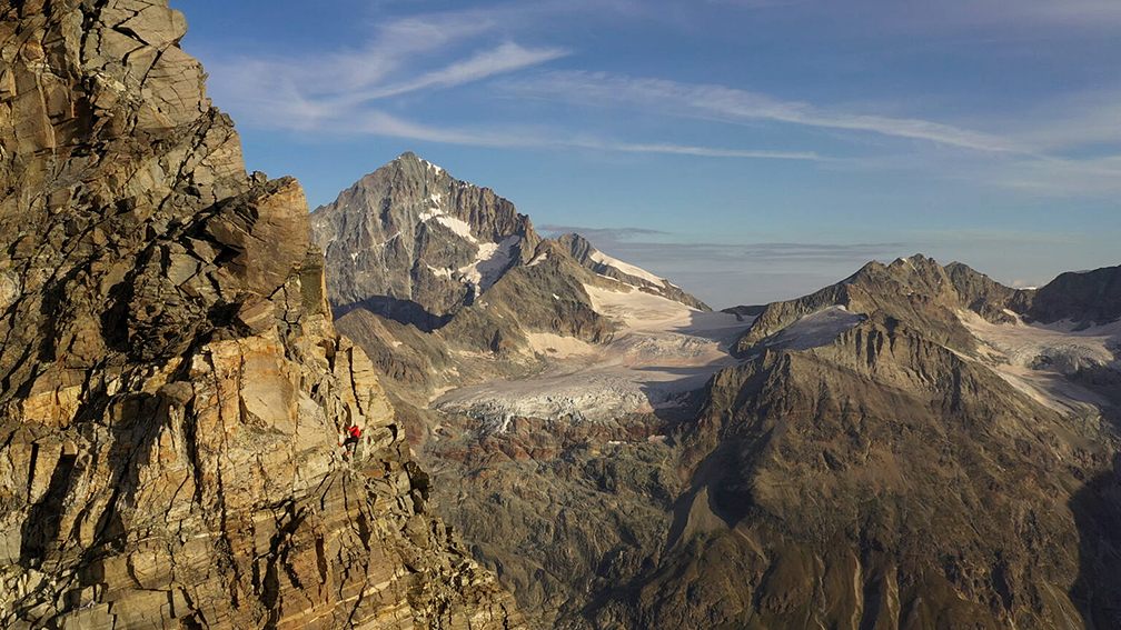 small figure in red on mountain