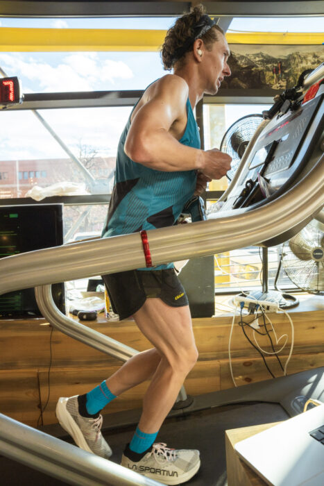Tyler Andrews running in a treadmill indoors. 