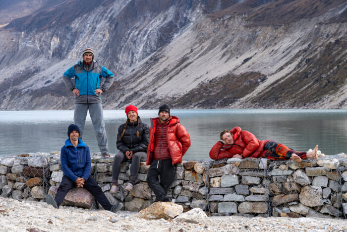 climbers beside a mountain lake