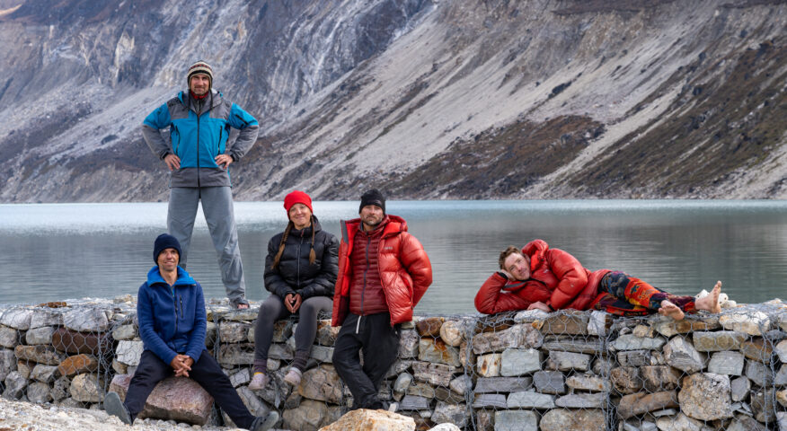 climbers beside a mountain lake