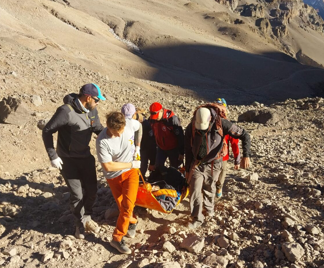 rescuers carry a litter with a person on it