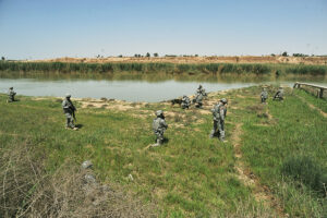 soldiers along a river in a desert