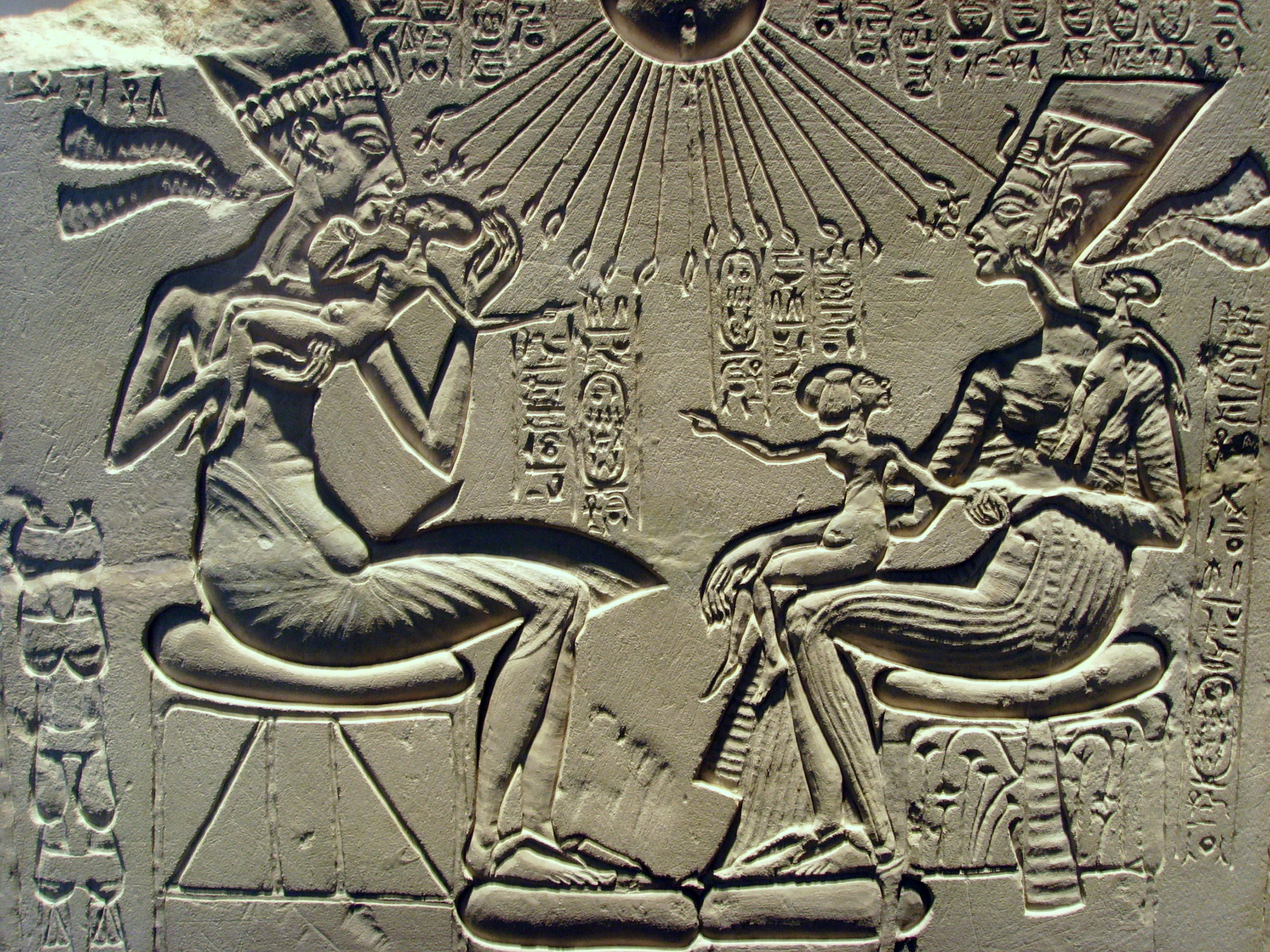 Carving of a man and woman seated with children