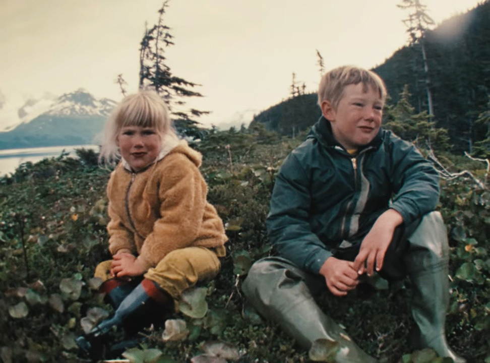 Two children sitting outside