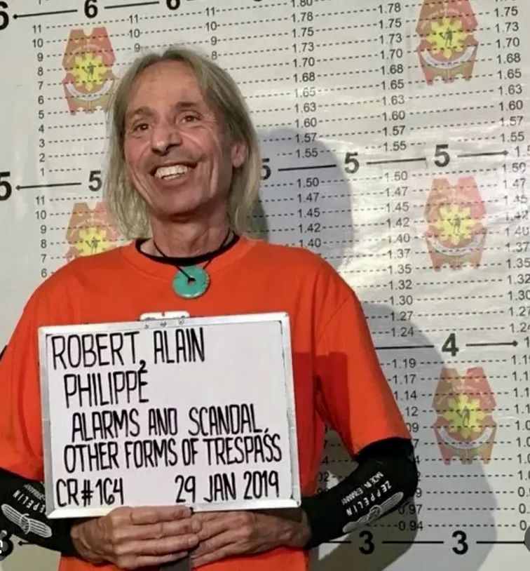 Alain Robert after being arrested due to an unauthorized urban free solo climb.