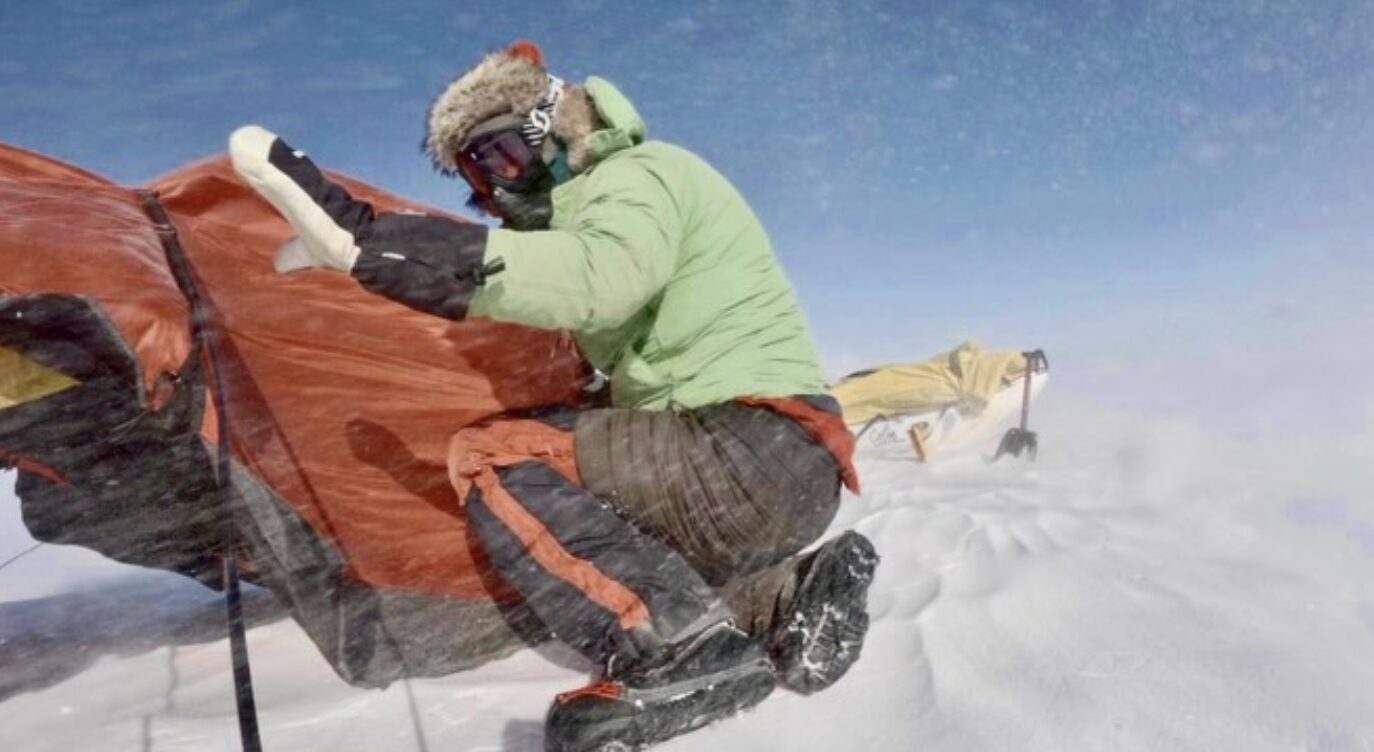 Colin O'Brady struggling with his tent in high winds. 