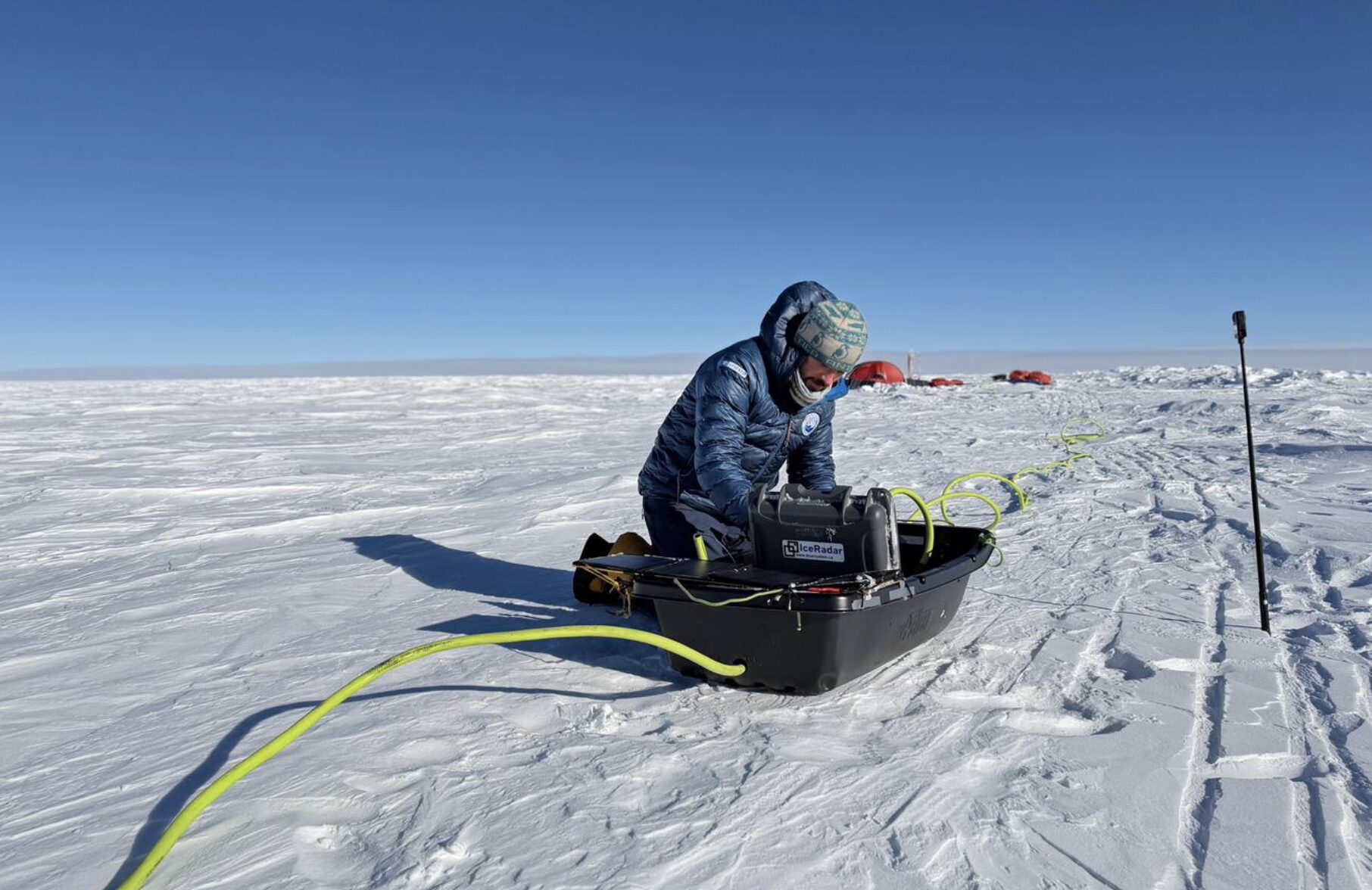 Matthieu Tordeur setting up scientific equipment in Antarctica.