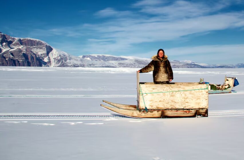 Galya Morrelll stands with a box sled on the Uummannaq Fjord in Northern Greenland.
