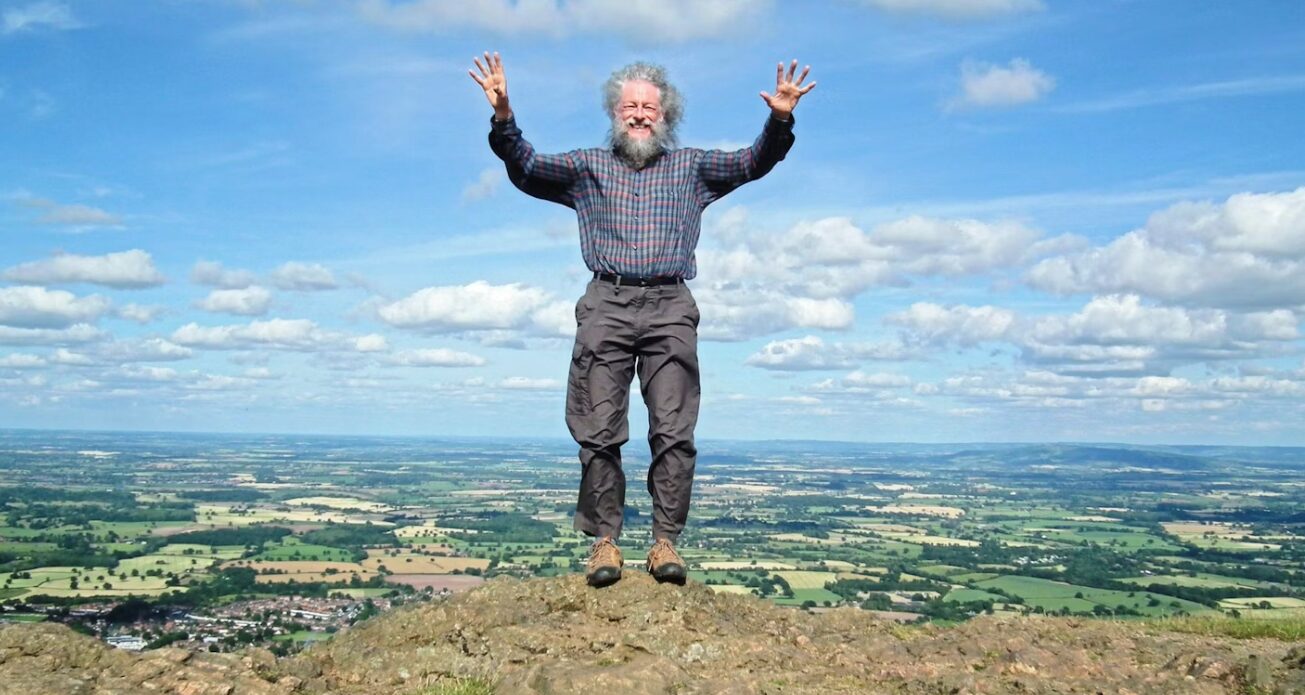 Jeff Kent stands atop a hill in England