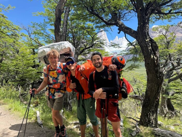 Climbers and BASE jumpers trekking with heavy backpacks in Patagonia.