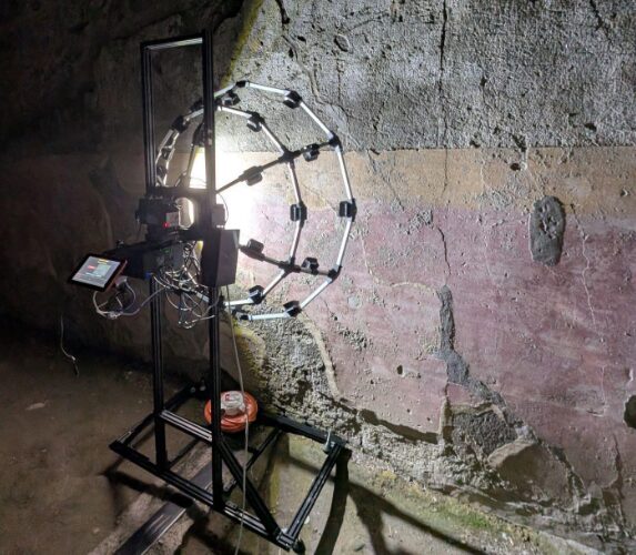 A fancy camera and lights pointed at a wall