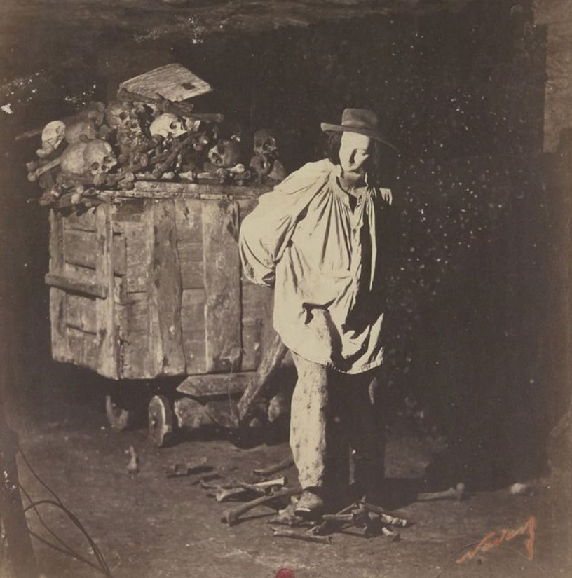 A mannequin with a cart full of human bones