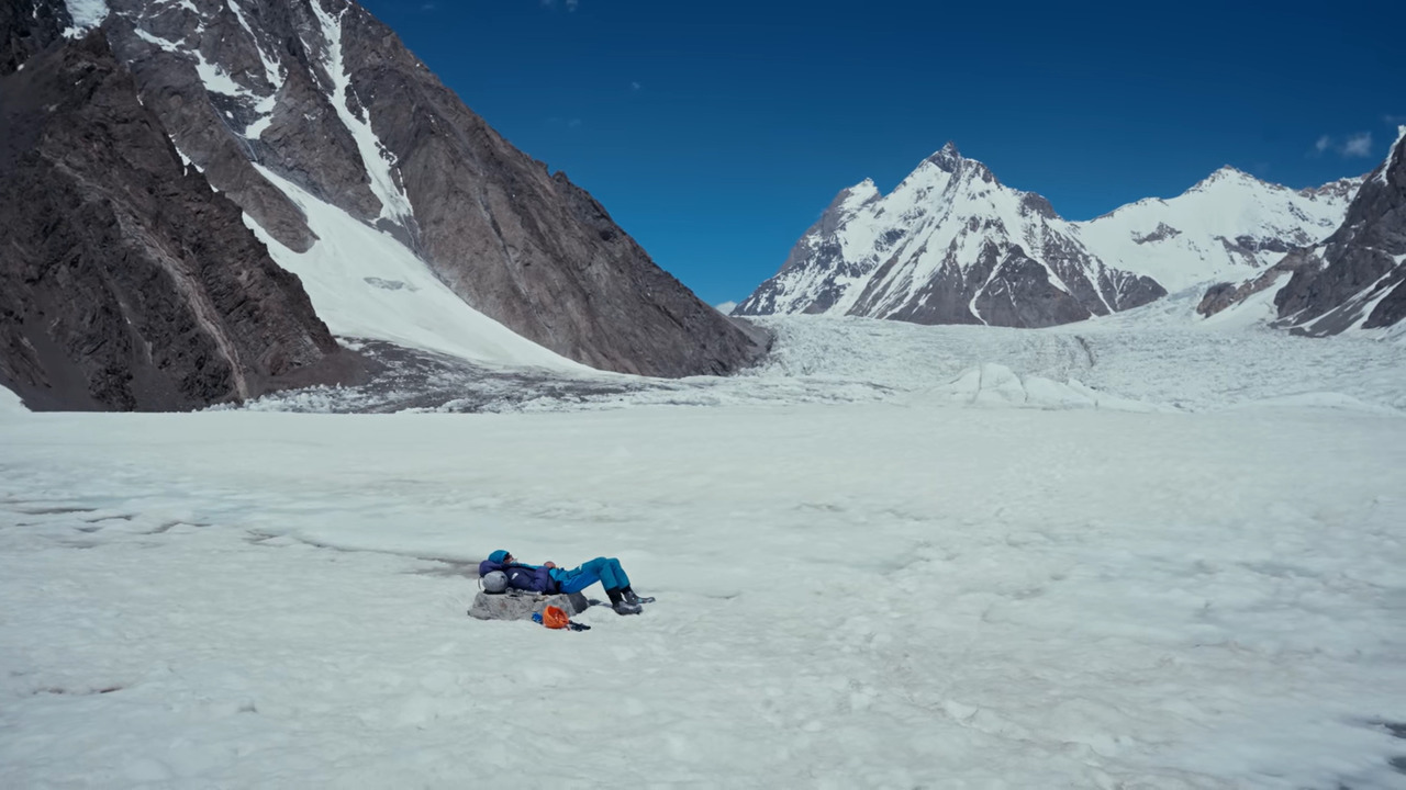 A man lying in the snow on K2