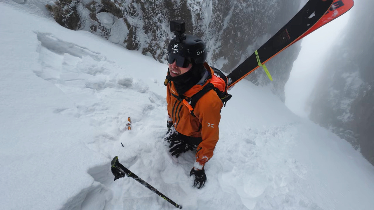 red jacket man stands in deep snow