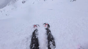 A man being swept away in a wave of loose snow