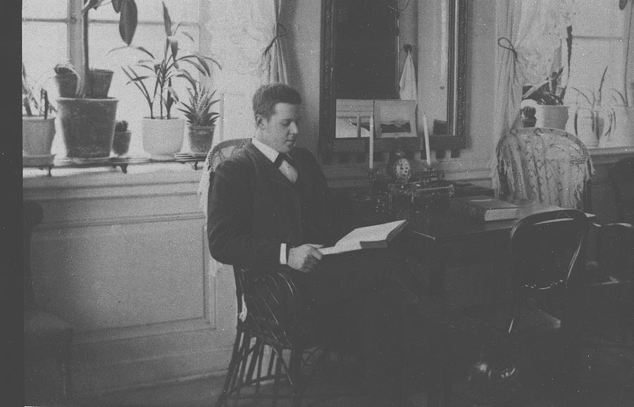 young man seated reading