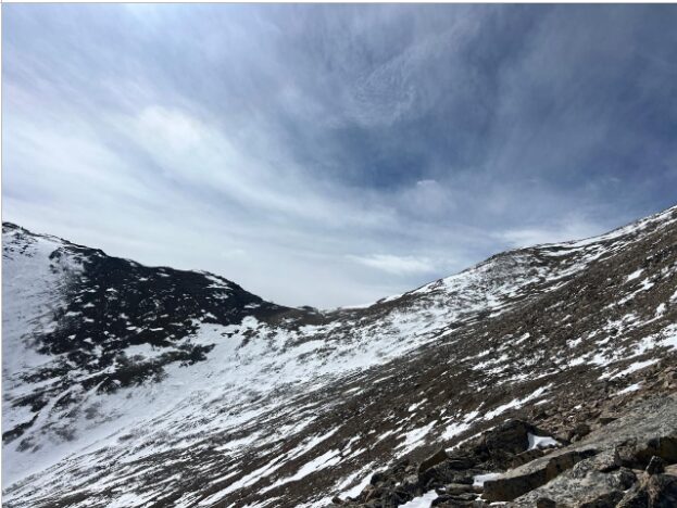 A slope on scree terrain and some snow. 