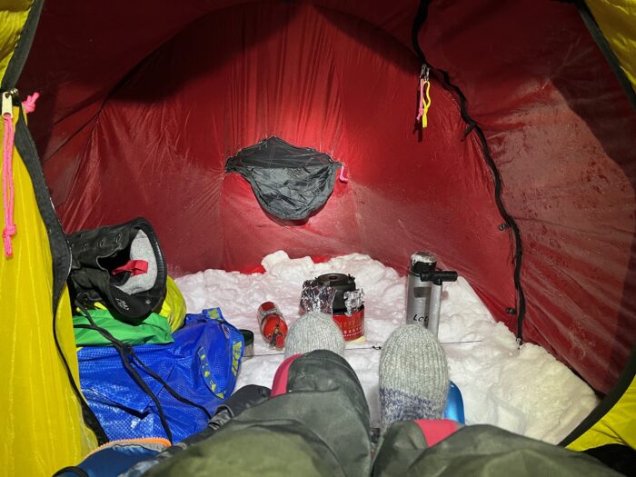 The inside of Kneip's tent showing a snow floor, stove and other equipment