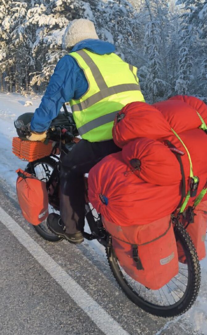 winter cyclist on heavily loaded bike