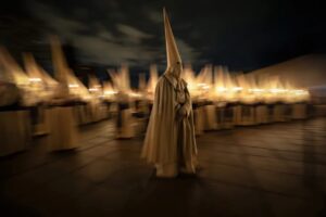 A lone penitent walks across Zamora’s Plaza de la Catedral during the Yacente procession at Zamora
