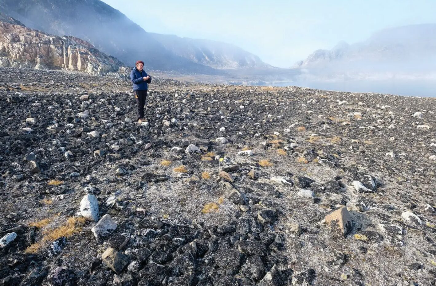 Study co-author Mari Kleist studying a Paleo-Inuit tent ring.