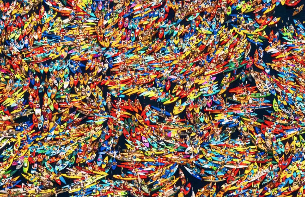 An aerial view of hundreds of colourful kayaks
