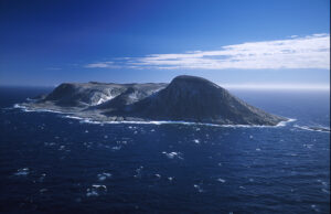 rocky island in a choppy ocean