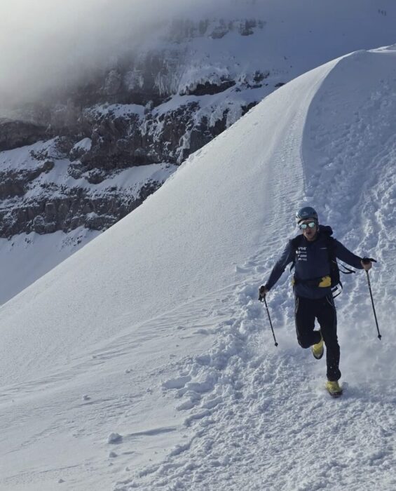 Egloff running down a snowy ridge on Cotopaxi. 