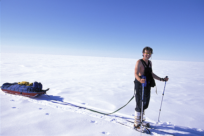 shirtless sledder smiling broadly