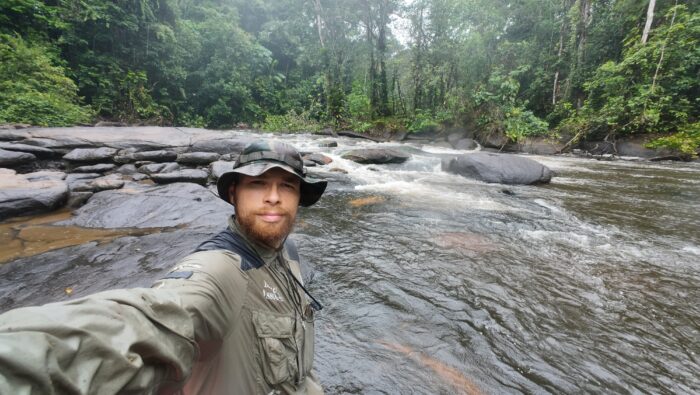 Swiss adventurer Loic Cappellin stands next to a river