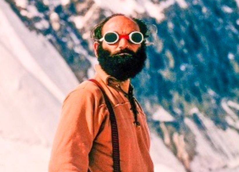 bald bearded climber in glacier glasses