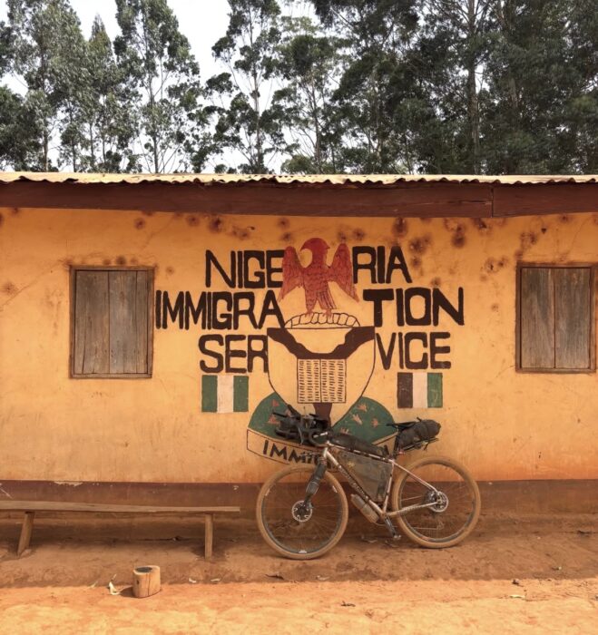 A Nigerian Immigration Service building with Swiss cyclist Adrien Liechti's bike resting against the wall of the building