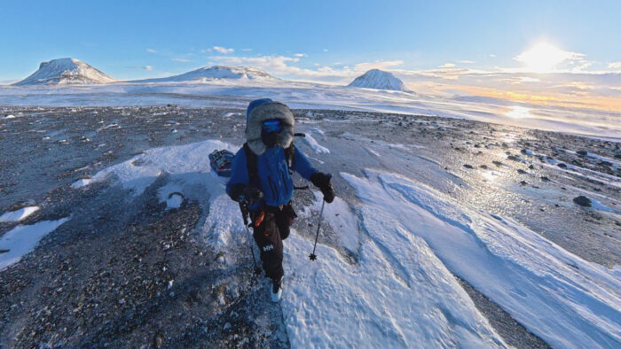 Stephane Weissbaum pulling a sled over rocky ground
