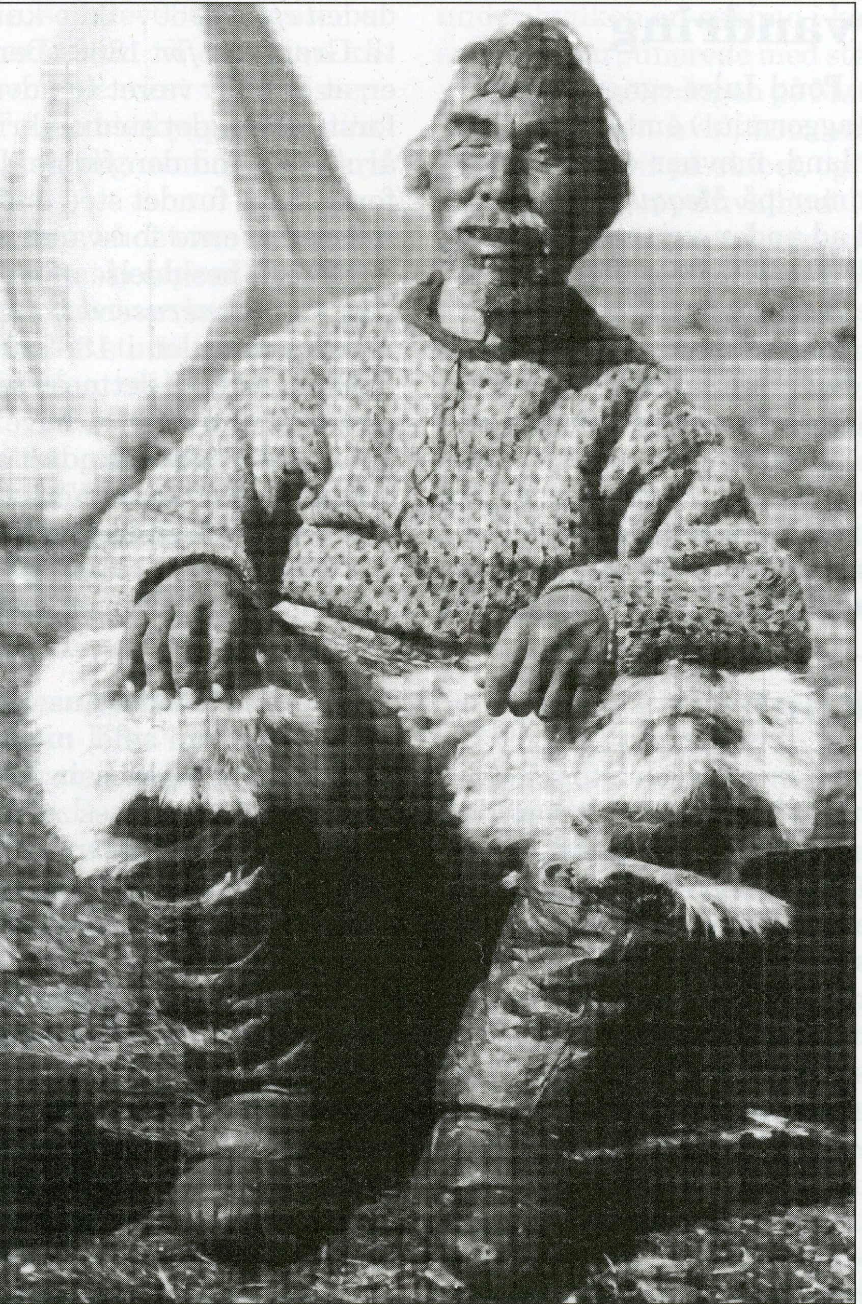 old photo of Inuit man seated