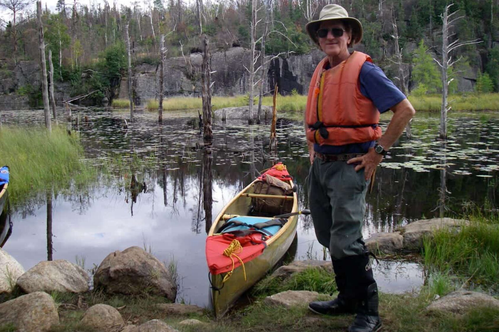 Cliff Jacobson stands next to his canoe