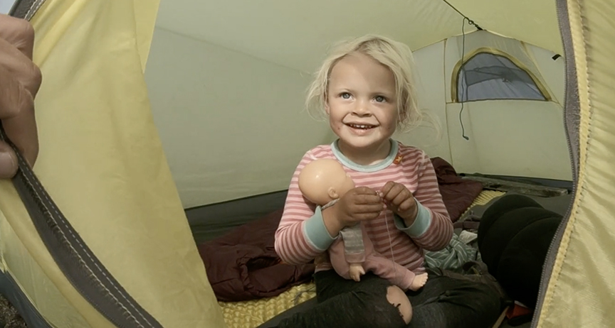girl in tent with doll