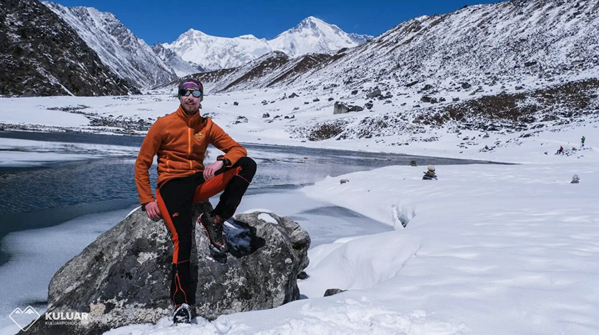 hiker at wintry lake edge