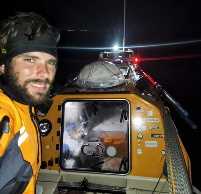 Italian adventurer Lorenzo Barone in the cockpit of his row boat at night in the Atlantic