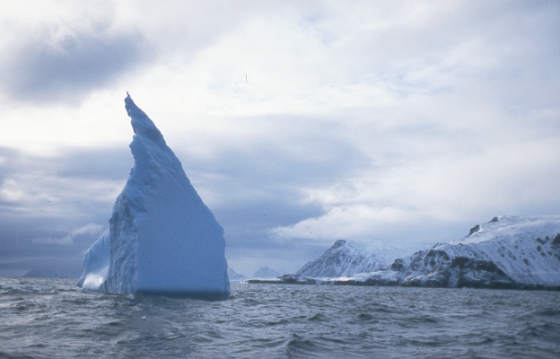 arctic scene with sea, iceberg, land
