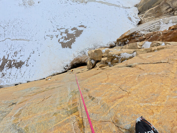 A rope down a vertical rock section of a mixed climb. 