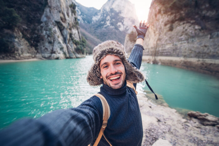 Man posing for selfie in a rive canyon