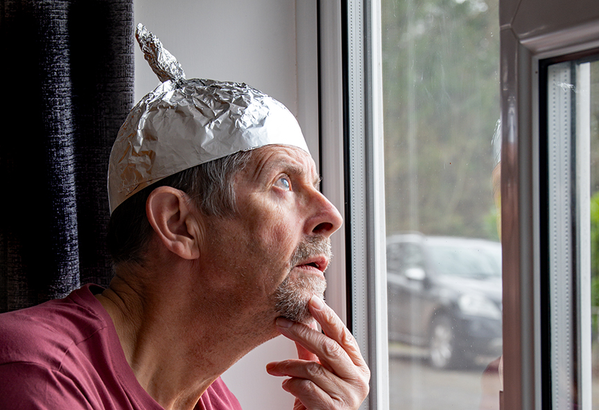 guy wearing tinfoil hat looking at heavens