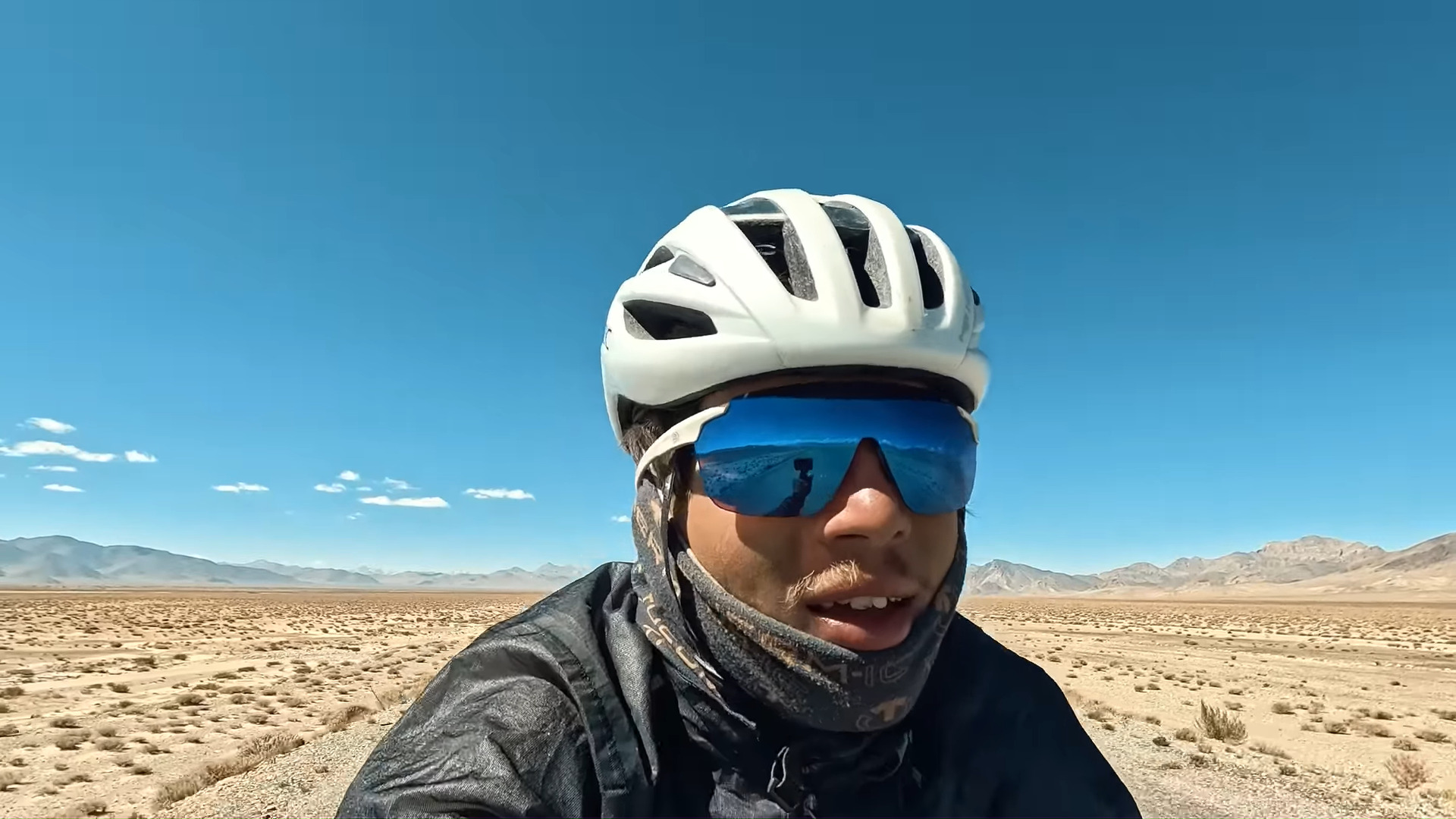 A man cycling in the desert
