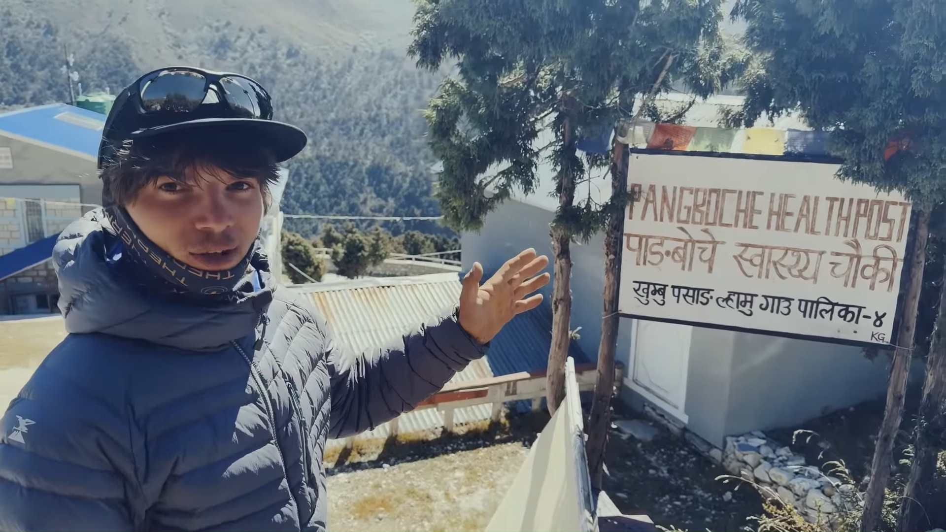 A young man in front of a health centre