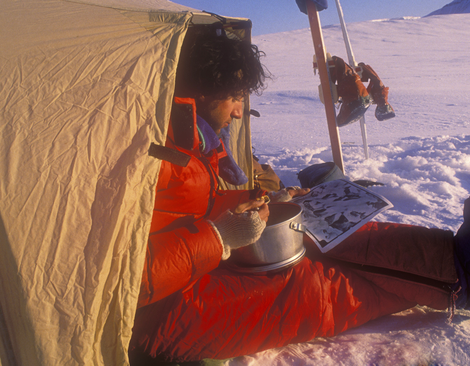 guy eating dinner by tent