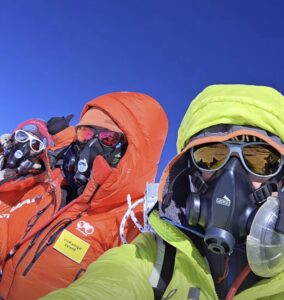 Three climbers covered by O2 masks.