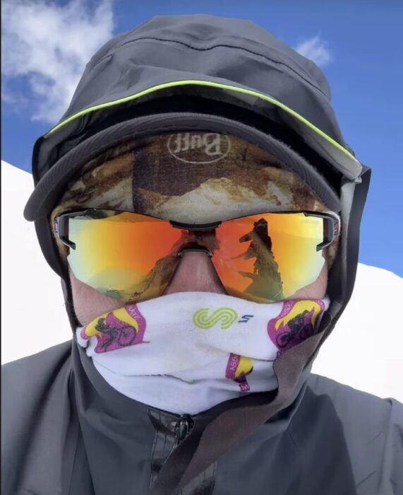 Close shot of Domi Trastoy with sunglases and a baclava covering his face. 