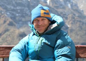 Close shot of Peter hamor sitting on a bench while trekking in Nepal.