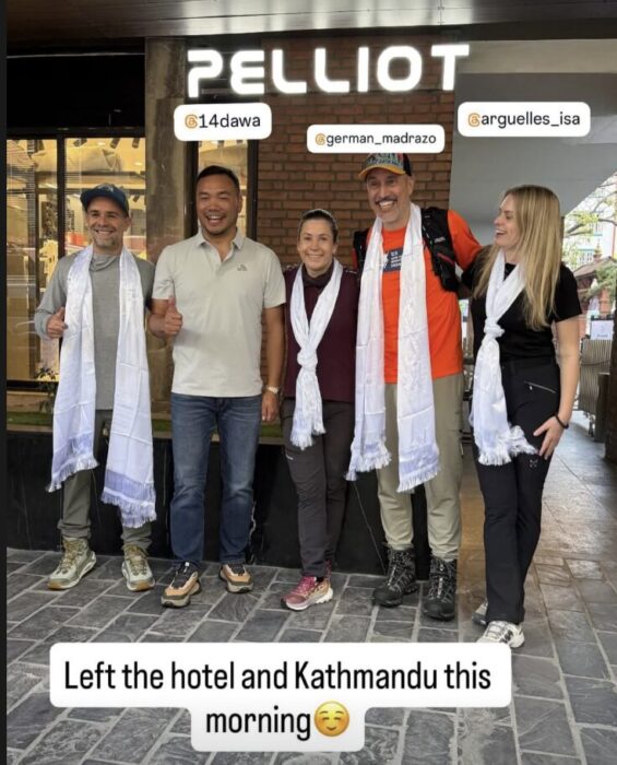 Climbers in front of their hotel, wearing khata scarves. 