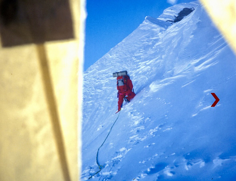 climbers going up snow slope, seen from tent